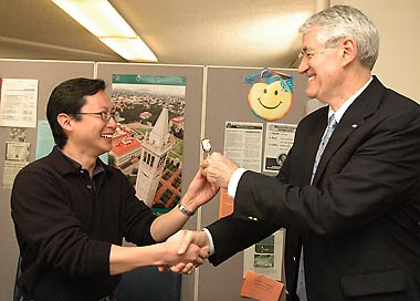 Charles Man Fong Tung receives his lollipop reward from Chancellor Birgeneau
