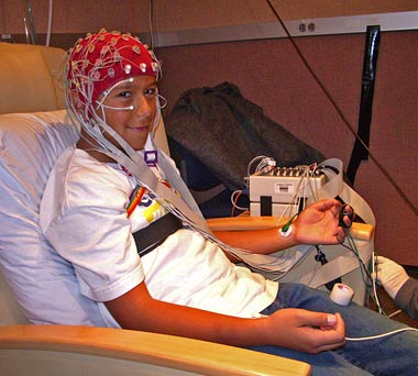 Child wired for EEG to test brain function