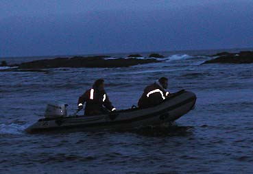 Zodiac launched into the surf at night