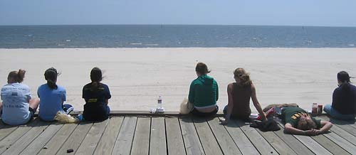 Students take a break on the beach boardwalk