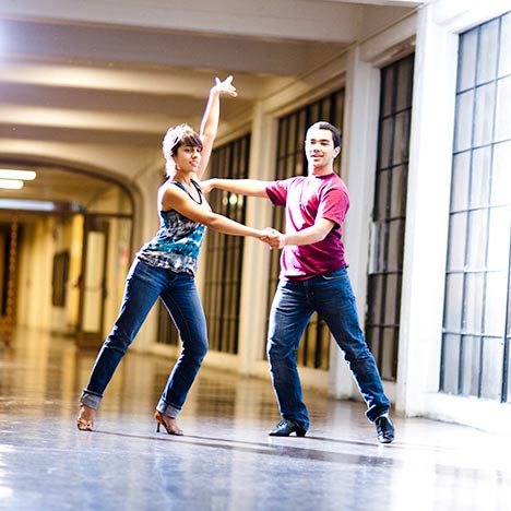 Two people dancing in a hallway