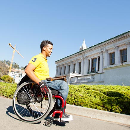 male in wheelchair in front of Doe Library