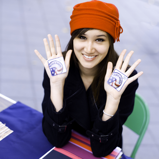 Female with red hat and stickers on her hands
