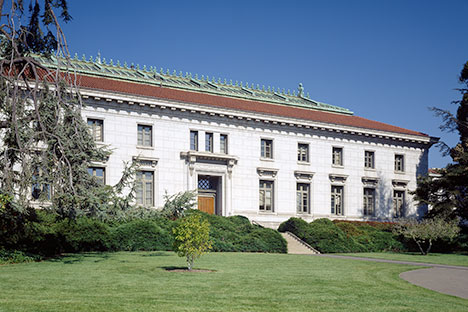 White building with red tile and copper roof