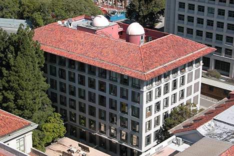 Aerial view of building with red tile roof and observatories on top