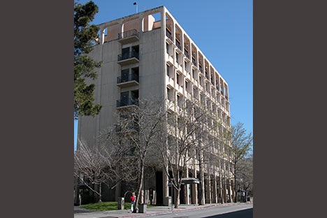 Multi-story building with bare trees in front