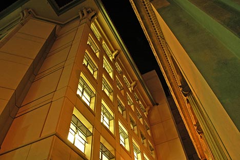 View of illuminated building at night looking up