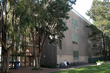 Side of building with trees and bikes in rack