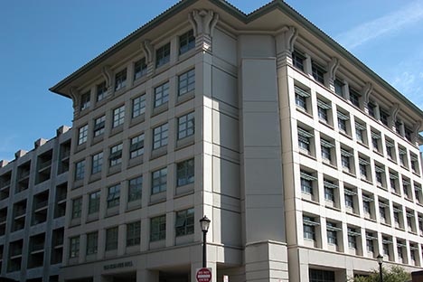 Multi-story building with lots of windows and blue sky