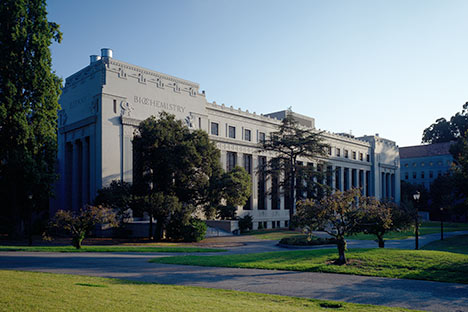 large building with Biochemistry written in large letters, lawn, walkways, and trees in front