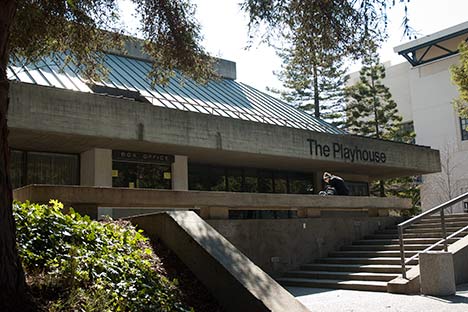 Building with signage reading 'The Playhouse' and low stairs leading to open area