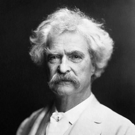 Black and white photo of Mark Twain with white hair and mustache