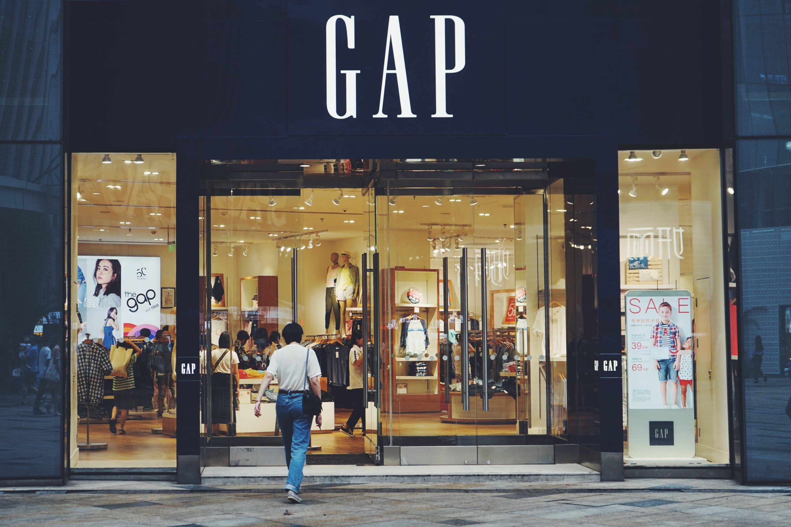Exterior of a Gap store, with people walking by